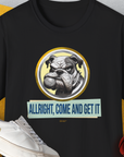 The Allright Come And Get It, Volume 1 shirt features a funny bulldog graphic with the saying ALLRIGHT, COME AND GET IT, encircled by a basketball. Designed by Dog Gang.