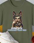 The military green tee showcases a dog disguised as a man with the words BEWARE OF THE UNDERCOVER POLICE DOGS, plus a shoe and basketball. Funny dog design. Designed by Dog Gang.