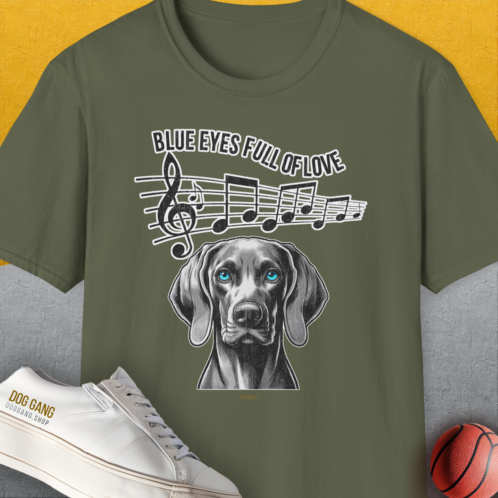 The military green T-shirt showcases a Weimaraner with music notes, perfect for any dog lover. Designed by Dog Gang.