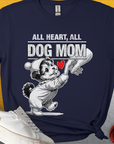 Dog lover tee features "All Heart, All Dog Mom" with a cartoon puppy holding a female Hand and a red heart. Perfect for any dog person. Designed by Dog Gang.
