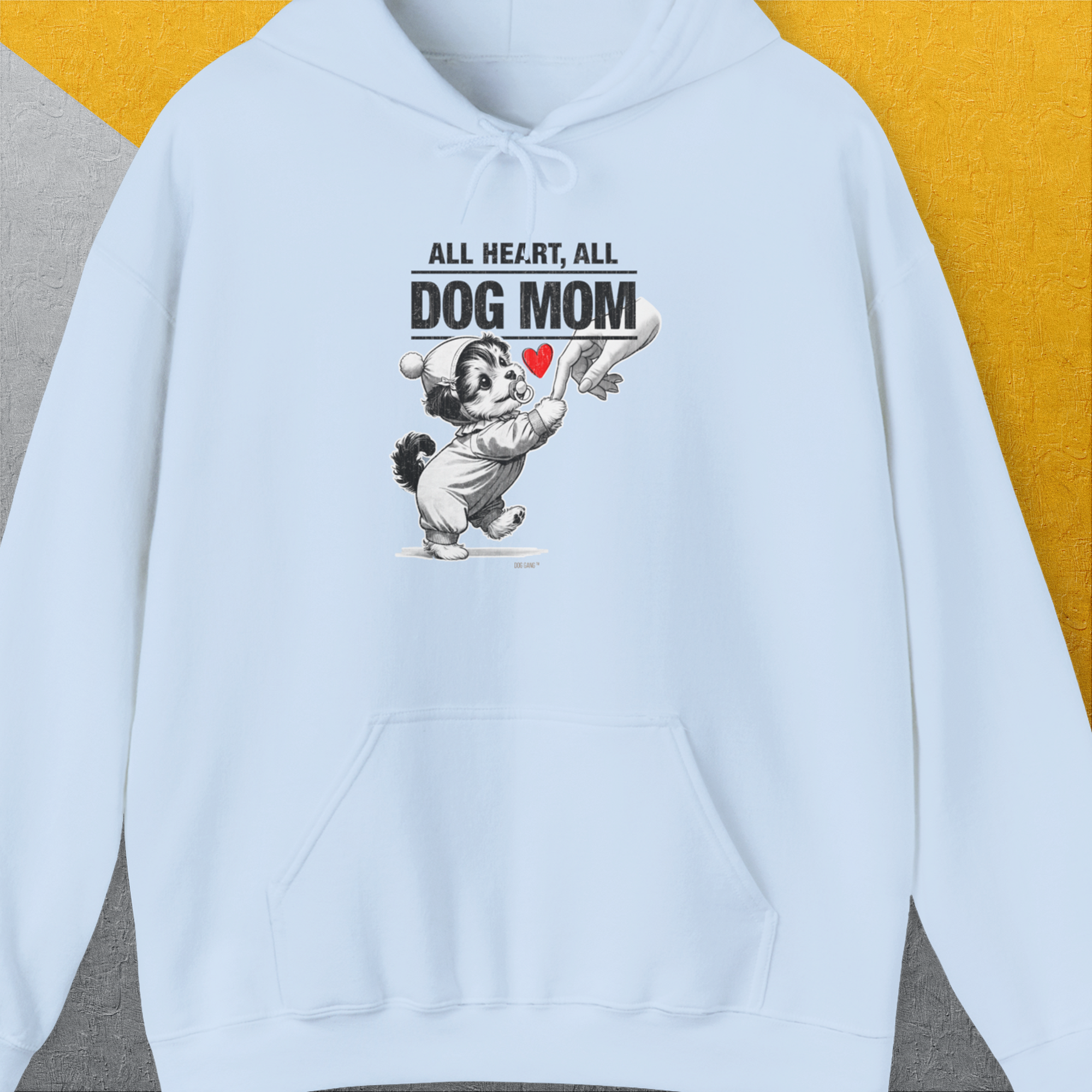 Unisex hoodie in light blue with a cute cartoon dog puppy holding a human hand under the quote All Heart, All Dog Mom. Perfect for any dog lover. Designed by Dog Gang.