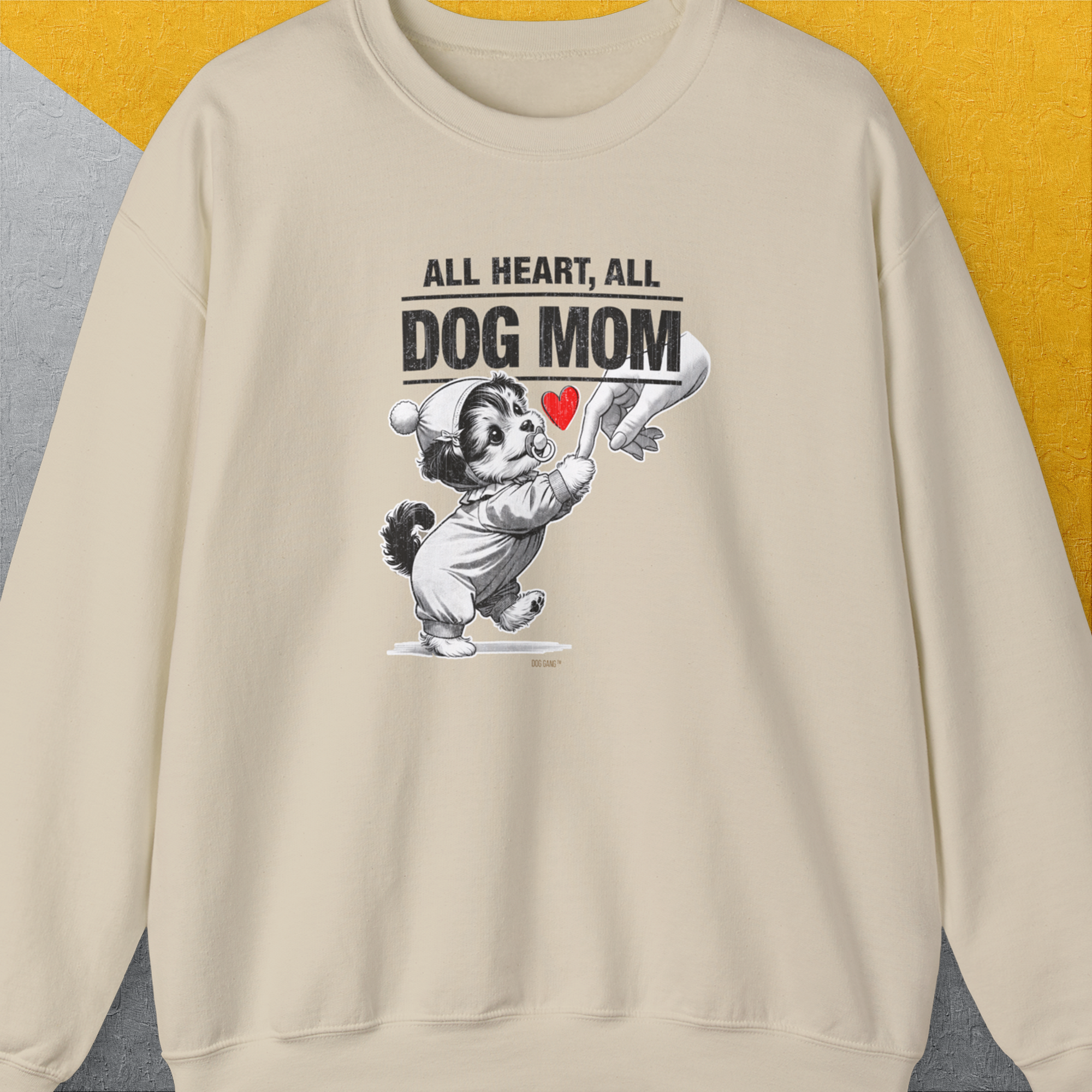 Cartoon dog with a red heart, "All Heart, All Dog Mom" quote. Cute dog design holding a woman's hand. For every loving dog mum. Designed by Dog Gang.
