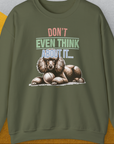 Military green sweatshirt with graphic of a poodle guarding his fetch ball, reading "DONT EVEN THINK ABOUT IT". Perfect for any dog lover, blending humor with style. Designed by Dog Gang.
