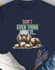 The Dont Even Think About It... shirt showcases a playful dog illustration with the phrase Dont even think about it. A funny dog shirt for any dog lover. Designed by Dog Gang.