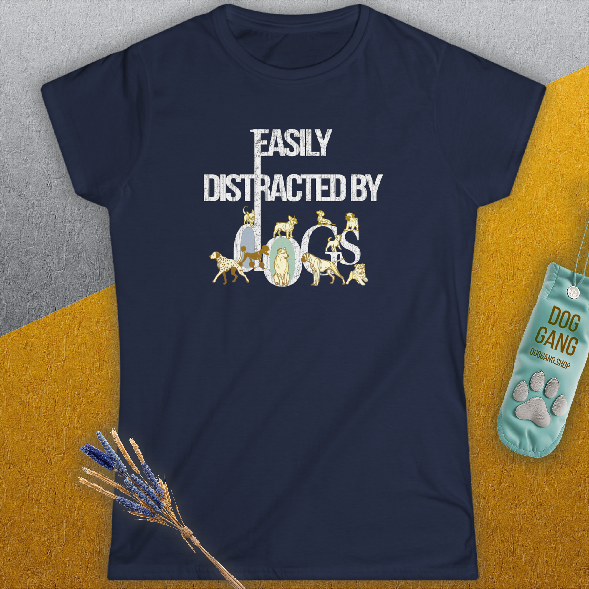 A navy blue womens T-shirt with the saying Easily Distracted by Dogs features playful dog images integrated into the white text, making it a perfect piece for any dog lover. Designed by Dog Gang.