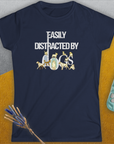 A navy blue womens T-shirt with the saying Easily Distracted by Dogs features playful dog images integrated into the white text, making it a perfect piece for any dog lover. Designed by Dog Gang.