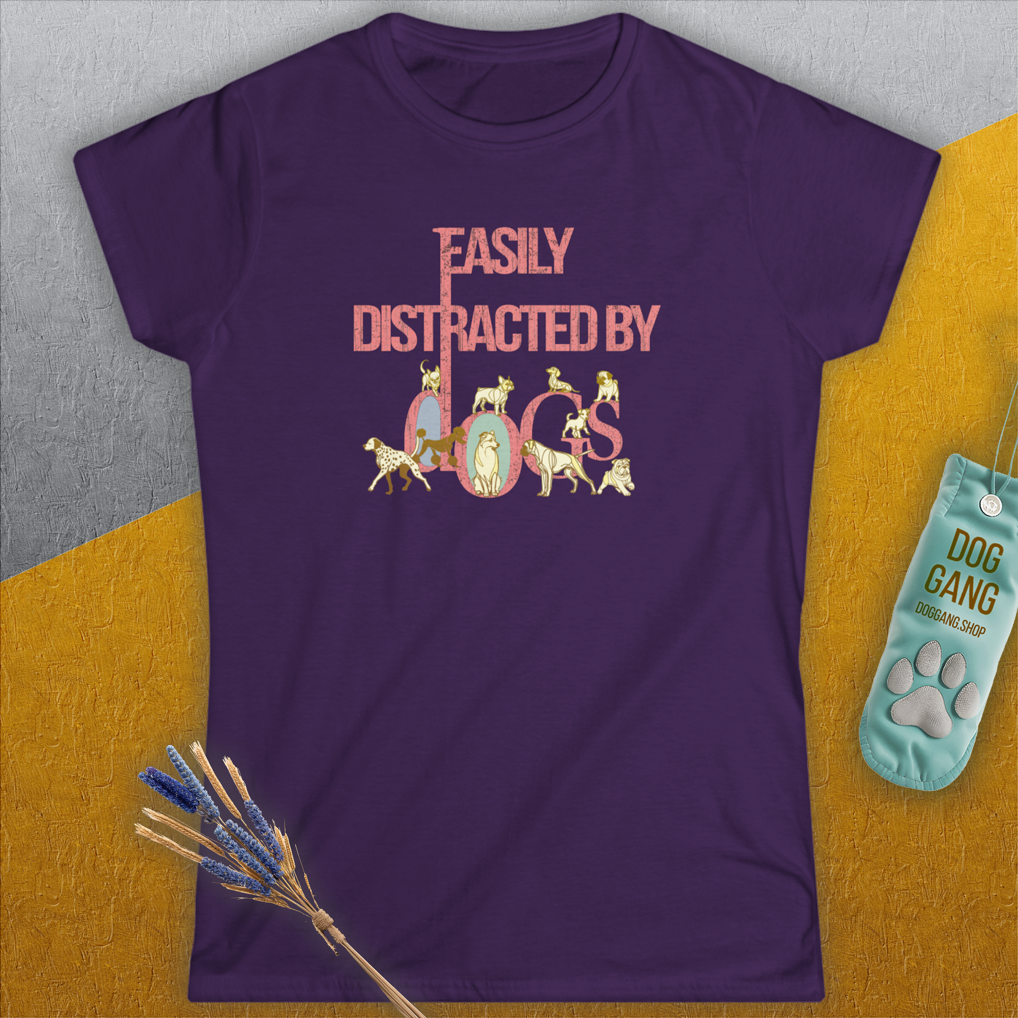 The Easily Distracted By Dogs Series, Volume 2 womens purple tee showcases a playful dog-themed design with pink and white text where the letters creatively incorporate illustrations of dogs. Designed by Dog Gang.
