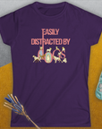 The Easily Distracted By Dogs Series, Volume 2 womens purple tee showcases a playful dog-themed design with pink and white text where the letters creatively incorporate illustrations of dogs. Designed by Dog Gang.
