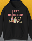 The black hoodie features playful dog illustrations with the saying Easily Distracted By Dogs. A perfect funny shirt for any dog lover. Designed by Dog Gang.