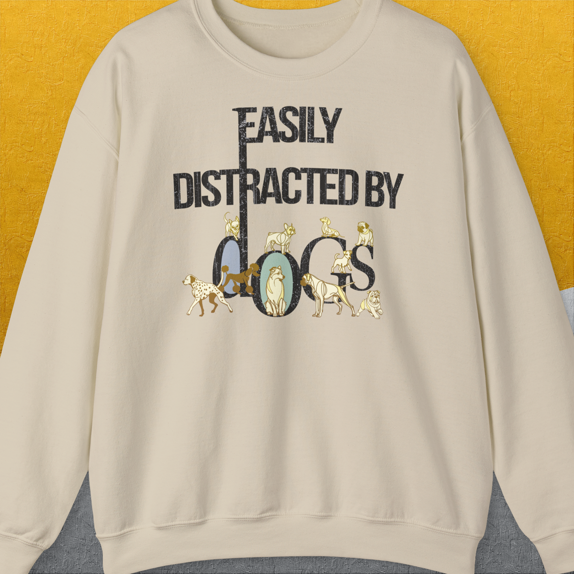 Unisex sweatshirt in sand features Easily Distracted by Dogs with charming dog illustrations. Cozy and stylish for any dog lover. Designed by Dog Gang.