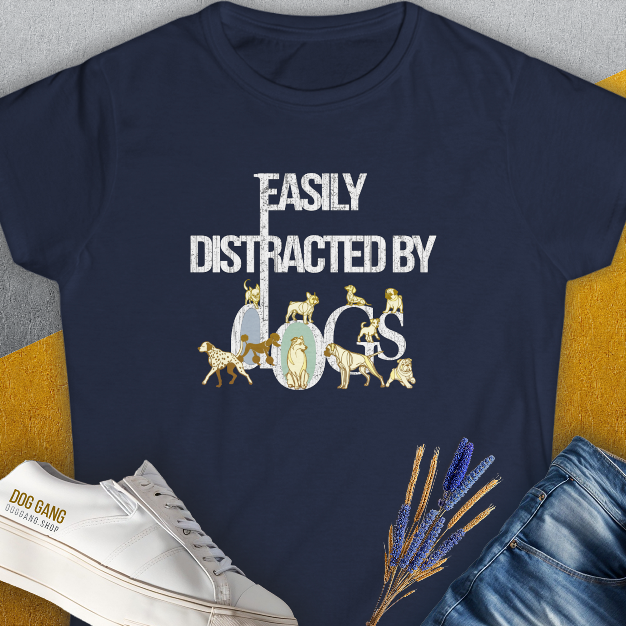 The Easily Distracted By Dogs Series, Volume 1, Womens T-Shirt in navy displays the words Easily Distracted by Dogs in white and gold, accompanied by charming dog illustrations: a Dalmatian, a Golden Retriever, a Pug, a Poodle, Dachshund, French Bulldog, English Bulldog, Chihuahua, Husky and more. Designed by Dog Gang.