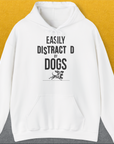 White hoodie with the phrase Easily Distracted By Dogs and a small dog illustration. Perfect for any dog lover. Designed by Dog Gang.