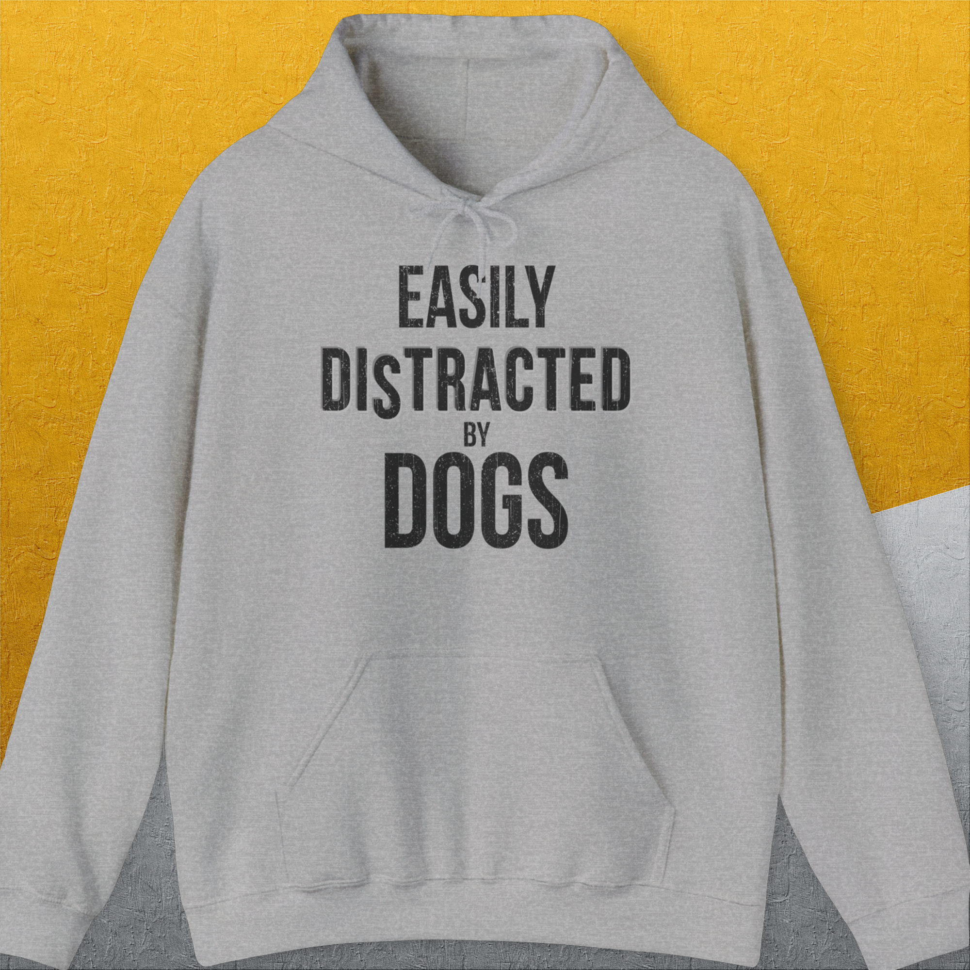 Vintage design with the bold quote EASILY DISTRACTED BY DOGS printed across the chest captures the essence of a dog lover. Designed by Dog Gang.