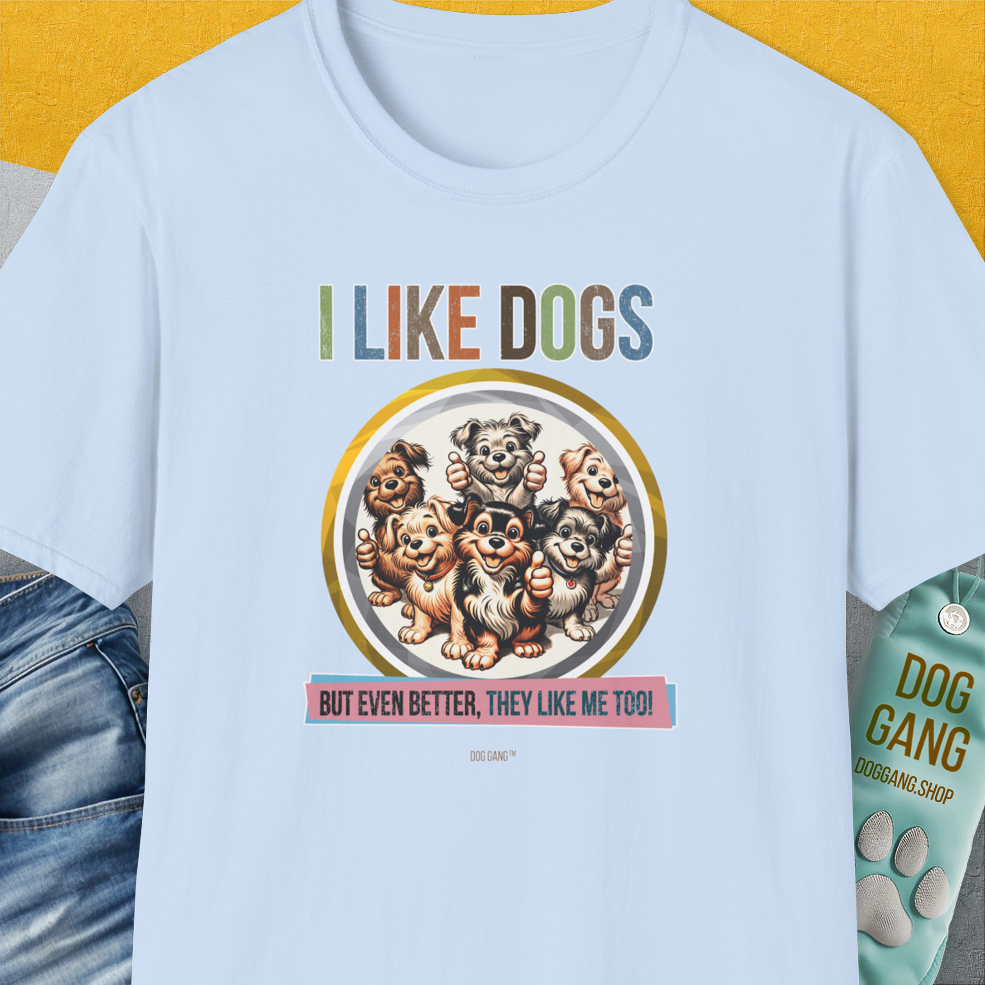 The light blue unisex T-shirt showcases cartoon dogs with the quote, I LIKE DOGS, BUT EVEN BETTER, THEY LIKE ME TOO! Perfect for any dog person. Designed by Dog Gang.