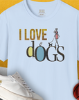 The unisex T-shirt features a woman walking dogs with the phrase I LOVE DOGS. A perfect dog lover gift, this light blue, 100% cotton tee is stylish and comfortable. Designed by Dog Gang.