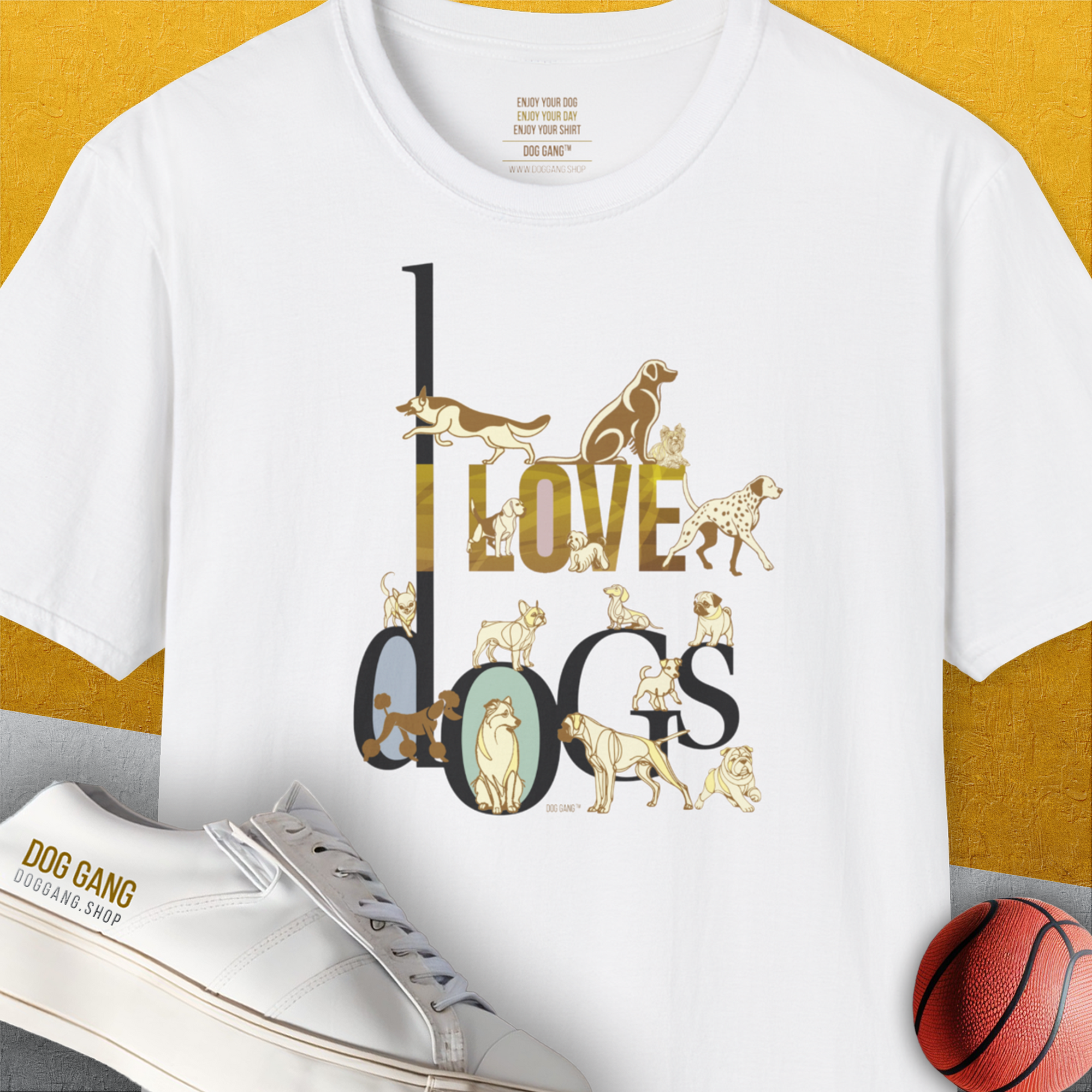 The I Love Dogs - Series I, Volume 1, Unisex T-Shirt is a white and soft-style tee that perfectly showcases the text I LOVE DOGS in an ornate gold / brown style, featuring illustrations of various dog breeds: a Dalmatian, a Golden Retriever, a Pug, a Poodle, Dachshund, French Bulldog, English Bulldog, Chihuahua, Husky and more. Designed in Switzerland by Dog Gang.