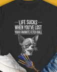 Sad dog (Chihuahua) illustration with "Life Sucks When Youve Lost Your Favorite Fetch Ball", Volume 6 text on a black womens T-shirt. A funny dog shirt for casual comfort. Designed by Dog Gang.