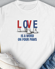 Designed by Dog Gang. The Love Is A Word On Four Paws, Volume 1, Womens T-Shirt features a cute dog design with Love is a word on four paws text accompanied by paw illustrations.