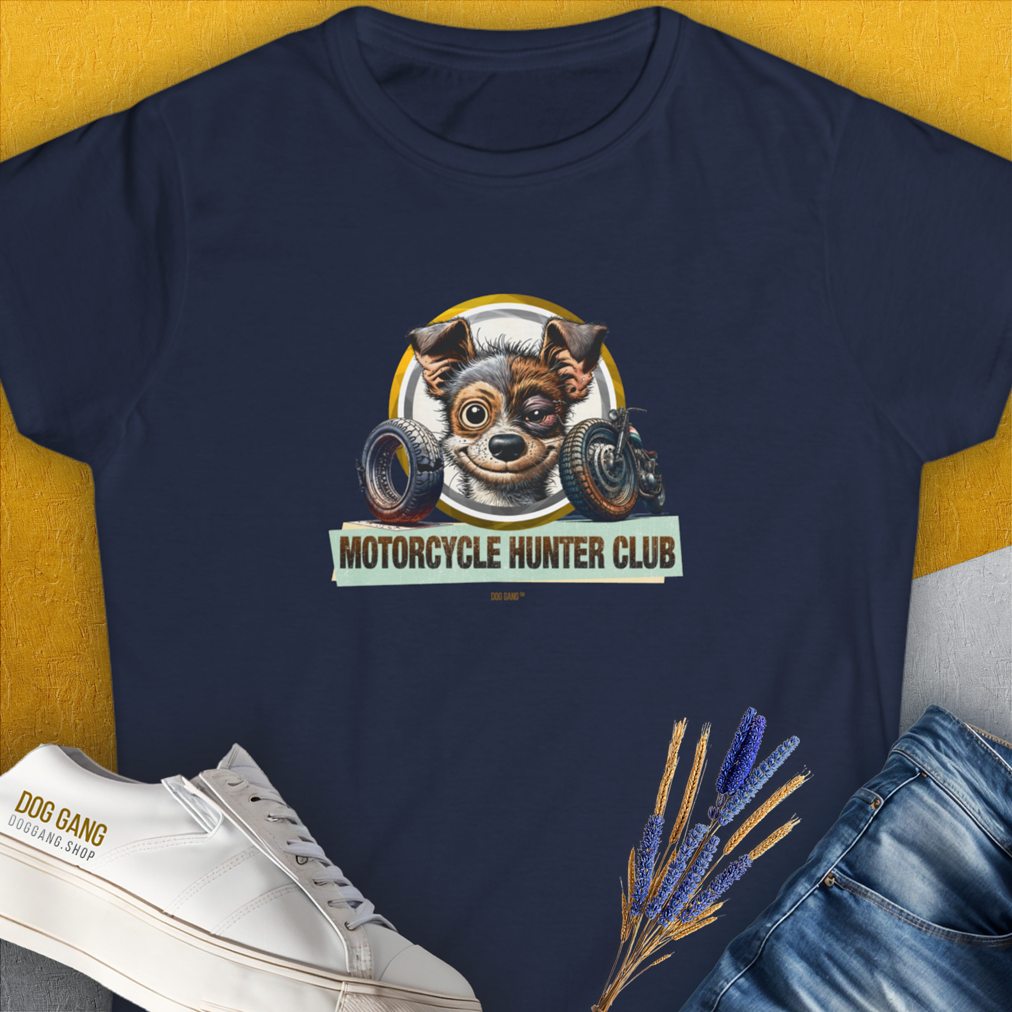 The Motorcycle Hunter Club, Volume 1, Womens T-Shirt in navy features a funny graphic of a slightly battered dog with a black eye and the slogan "Motorcycle Hunter Club". Perfect for any dog lover. Design by Dog Gang.