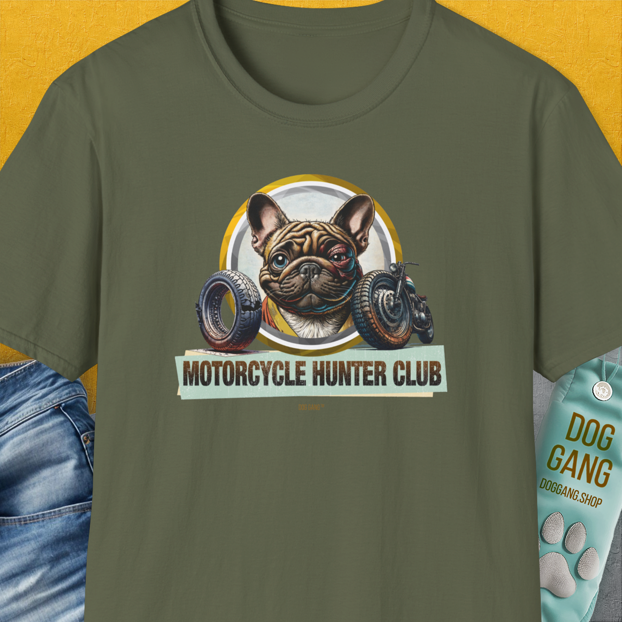 The funny Military Green unisex t-shirt, Motorcycle Hunter Club, Volume 3 (French Bulldog), features a slightly battered French bulldog with a black eye and the humorous slogan "Motorcycle Hunter Club". Designed by Dog Gang.