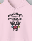 Unisex hoodie featuring a cartoon dog with balls and the quote My Dog Is Easily Distracted By - Volume 4: Other Dogs Fetching Balls in pink. A funny shirt for any dog lover. Designed by Dog Gang.