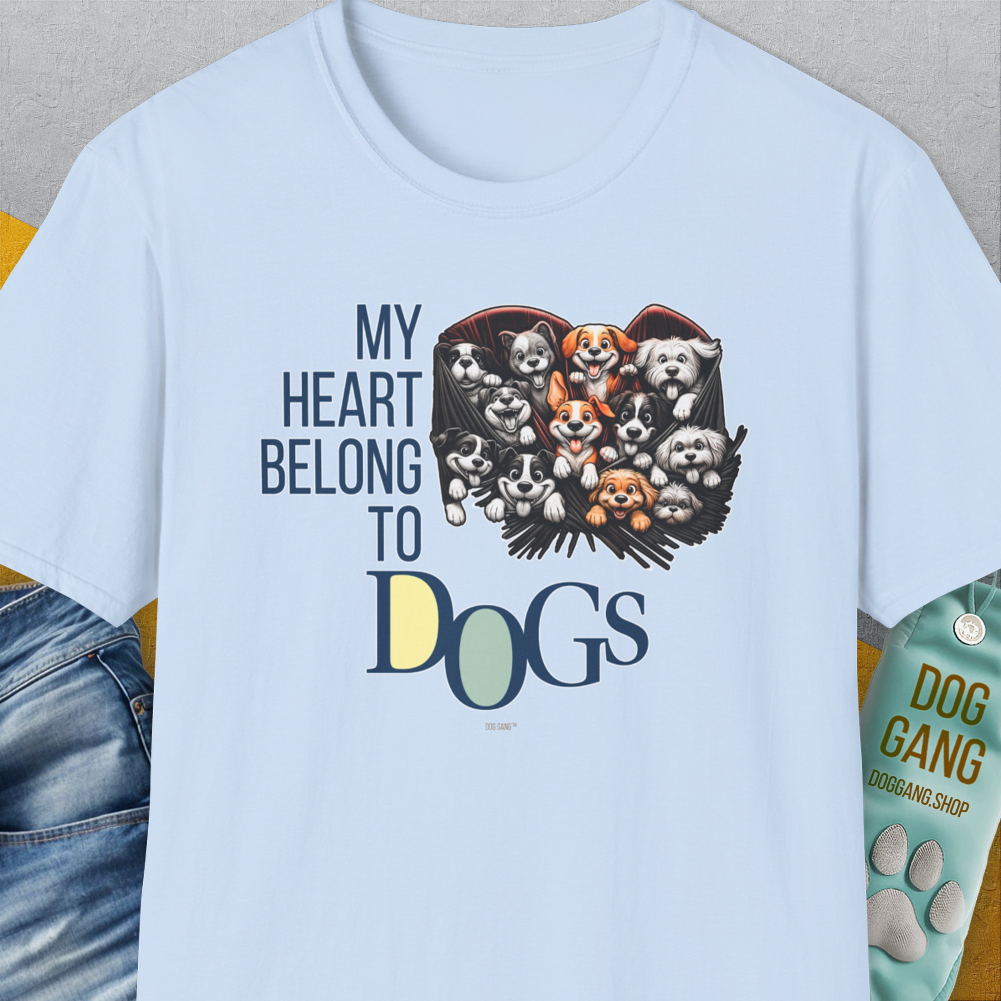 The My Heart Belongs to Dogs, Volume 1 light blue unisex T-shirt showcases cartoon dogs with the funny saying My Heart Belongs to Dogs. Designed by Dog Gang.