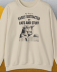 My Dog Is Easily Distracted By - Volume 2: Cats And Stuff, Unisex Sweatshirt-Sand, Design by Dog Gang