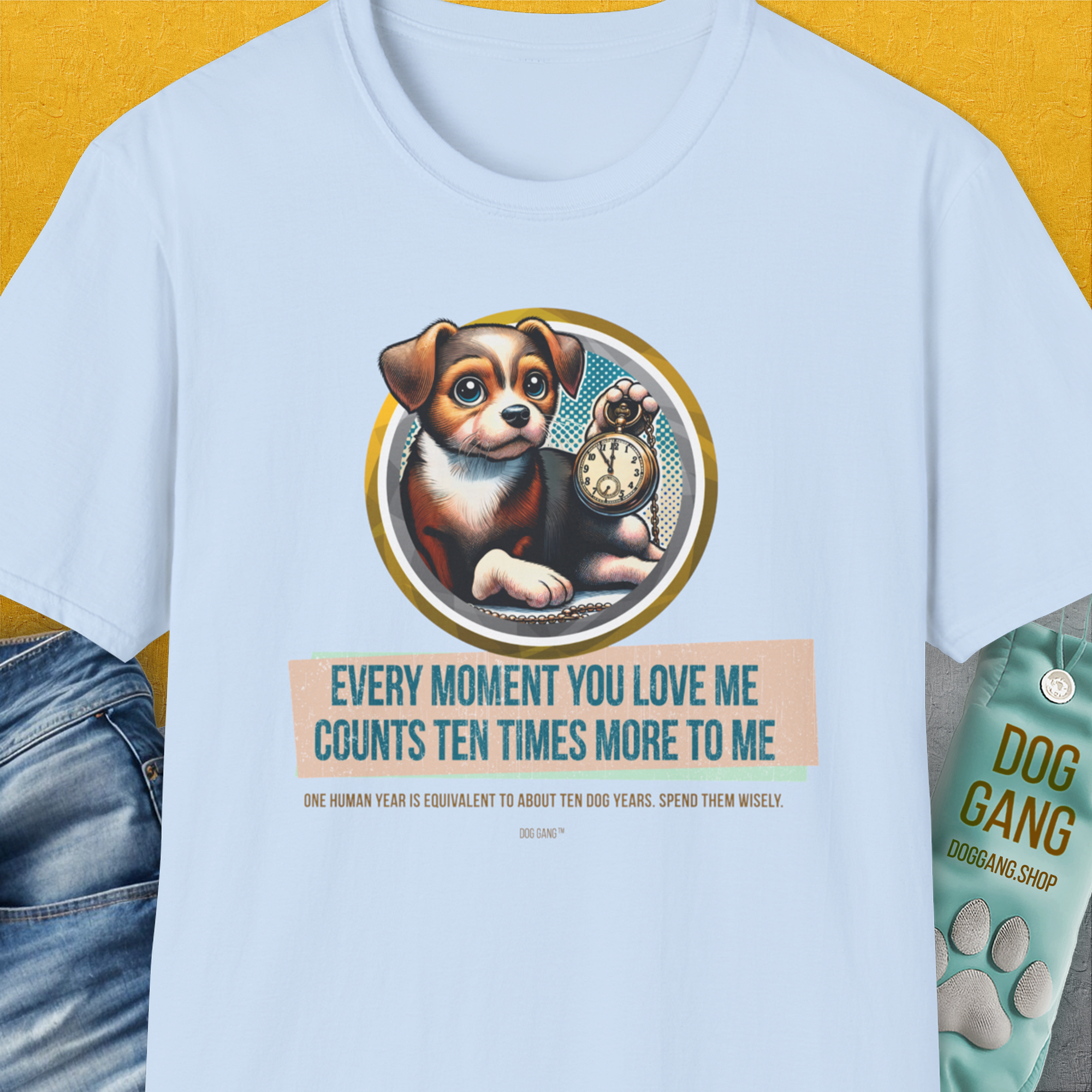 The light blue T-shirt showcases a cute puppy holding a clock with the saying, Every moment you love me counts ten times more to me. Perfect for any dog lover. Designed by Dog Gang.