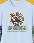 The light blue T-shirt showcases a cute puppy holding a clock with the saying, Every moment you love me counts ten times more to me. Perfect for any dog lover. Designed by Dog Gang.
