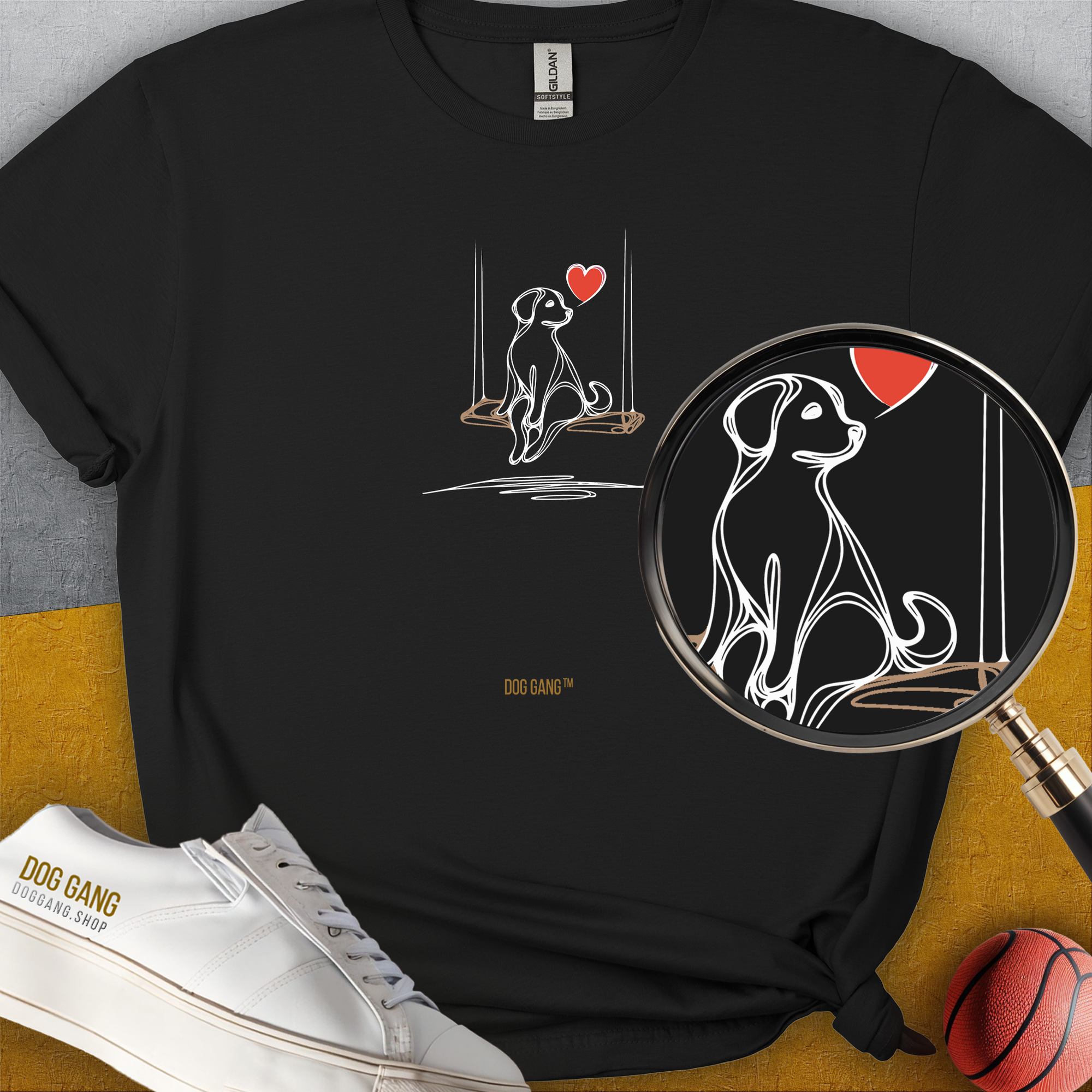 Minimalistic black tee featuring a dog on a swing beneath a red heart, perfect for any dog lover. Designed by Dog Gang.