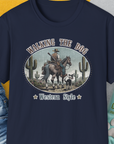 Our Walking The Dog, Western Style, Volume 2 unisex T-shirt in navy features a cowboy and dog design with cacti. Perfect for any dog lover gift. Designed by Dog Gang.