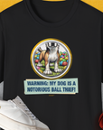 Unisex black T-shirt with dog graphic and the witty caption, Warning: My Dog Is A Notorious Ball Thief, Volume 2. Perfect for a funny dog shirt. Designed by Dog Gang.