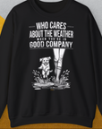 Das Unisex-Sweatshirt „Who Cares About The Weather When You're In Good Company?, zeigt die Beine einer Person in Regenstiefel neben einer süssen Hundegrafik. Entworfen von Dog Gang.