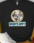 The Woofs Upp? Volume 1 T-shirt features a cartoon dog with a fetch ball in his mouth and the phrase "WOOFS UPP?" Perfect for any dog lover, its a fun and playful design. Designed by Dog Gang.
