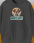 The Woofs Upp? Volume 2 hoodie highlights a funny dog design with a playful pup holding a bone and the text WOOFS UPP?. Perfect for any dog lover. Designed by Dog Gang.