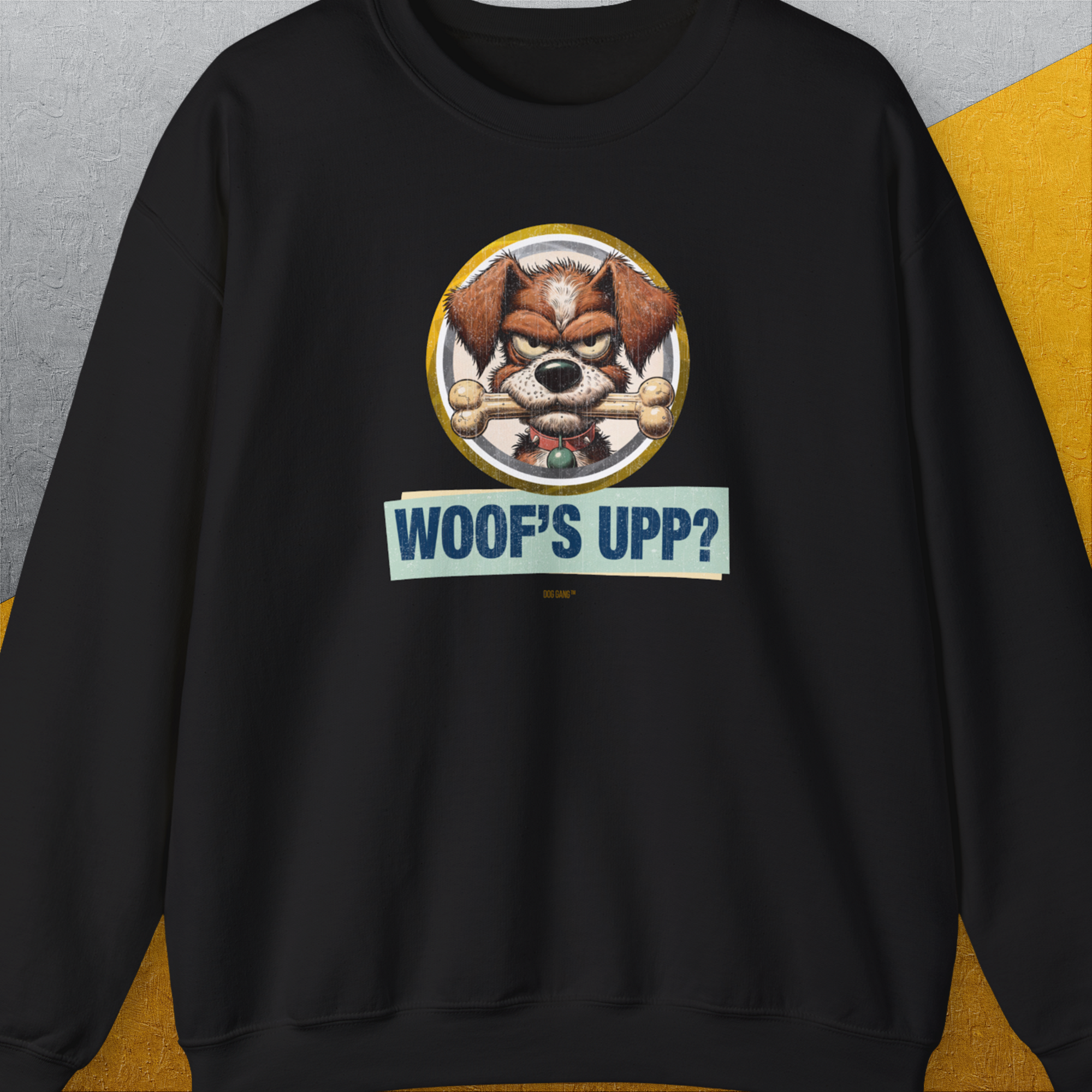 Unisex black sweatshirt, Woofs Upp? Volume 2, featuring funny design of a dog holding a bone with playful text. Designed by Dog Gang.