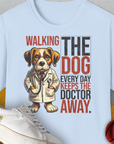 Walking The Dog Every Day Keeps The Doctor Away, Volume 1, Unisex T-Shirt-Light Blue-originelles und lustiges Hundeshirt, Design by Dog Gang
