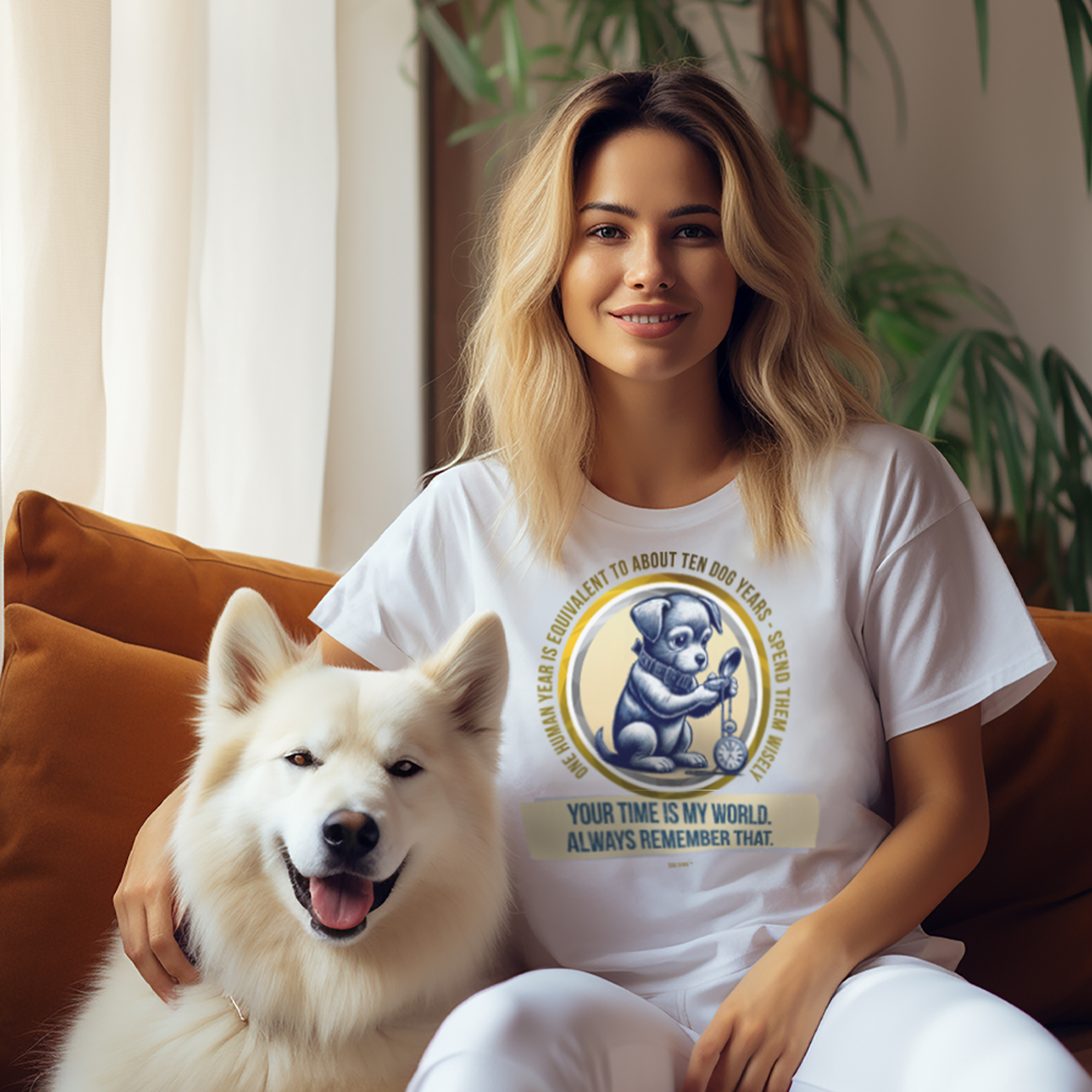 A woman sits on an orange couch next to a fluffy white dog. She wears a T-shirt with a design featuring a cartoon dog and text, including phrases about time and dogs. Sunlight filters through a window with a sheer curtain, and a plant is in the background.