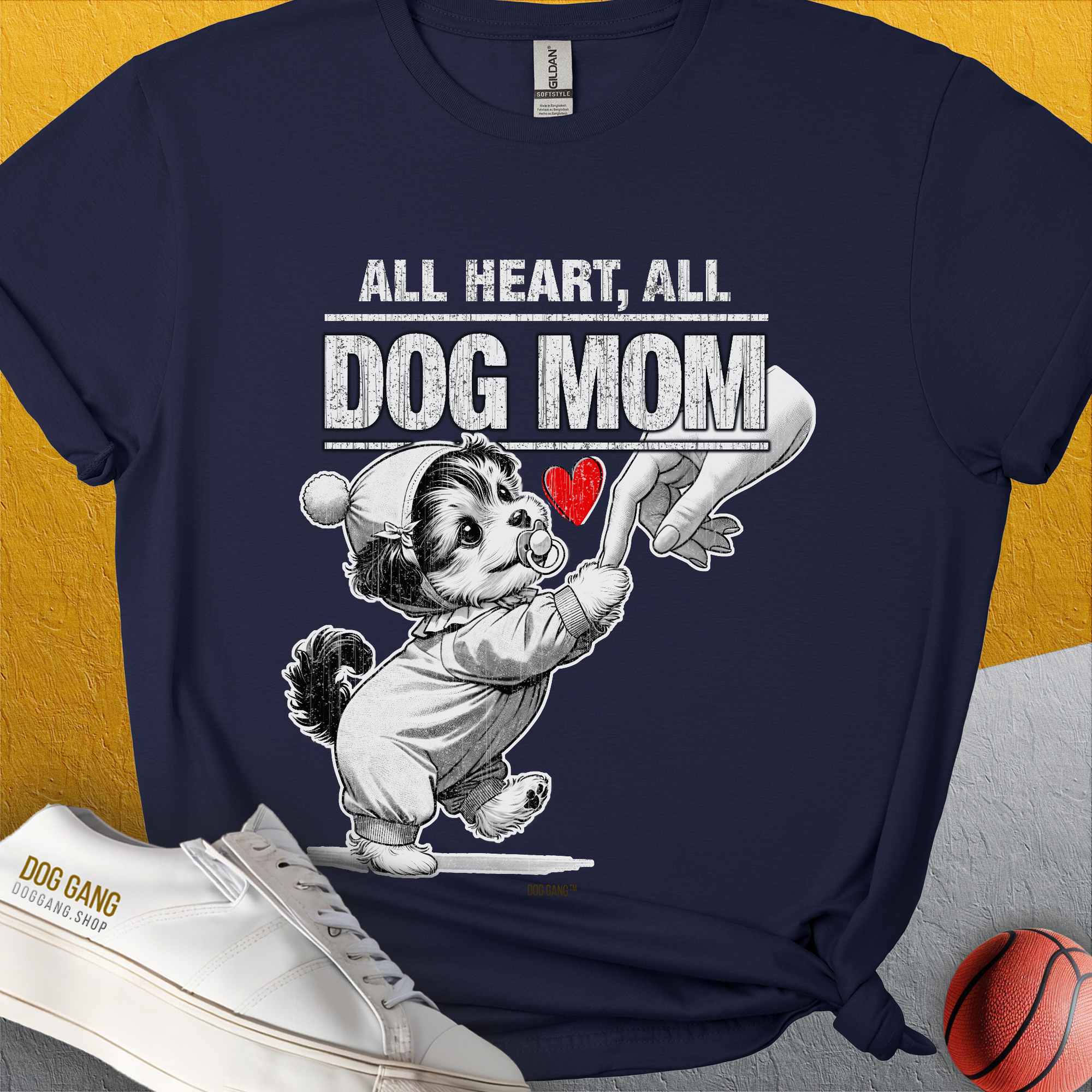 Dog lover tee features "All Heart, All Dog Mom" with a cartoon puppy holding a female Hand and a red heart. Perfect for any dog person. Designed by Dog Gang.