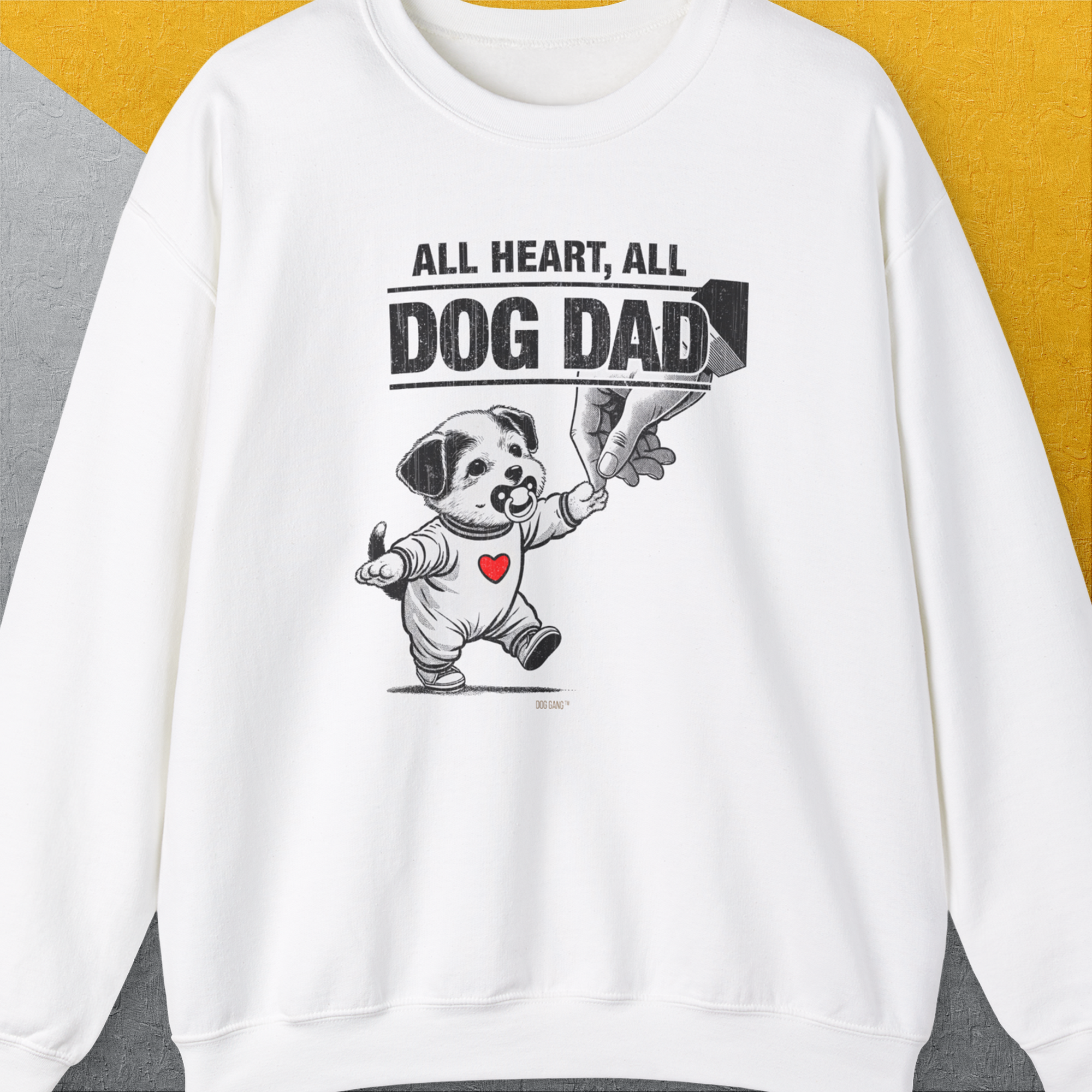 The Dog Dad Series, Volume 7 white sweatshirt features a puppy and heart graphic alongside the quote All Heart, All Dog Dad. Designed by Dog Gang.