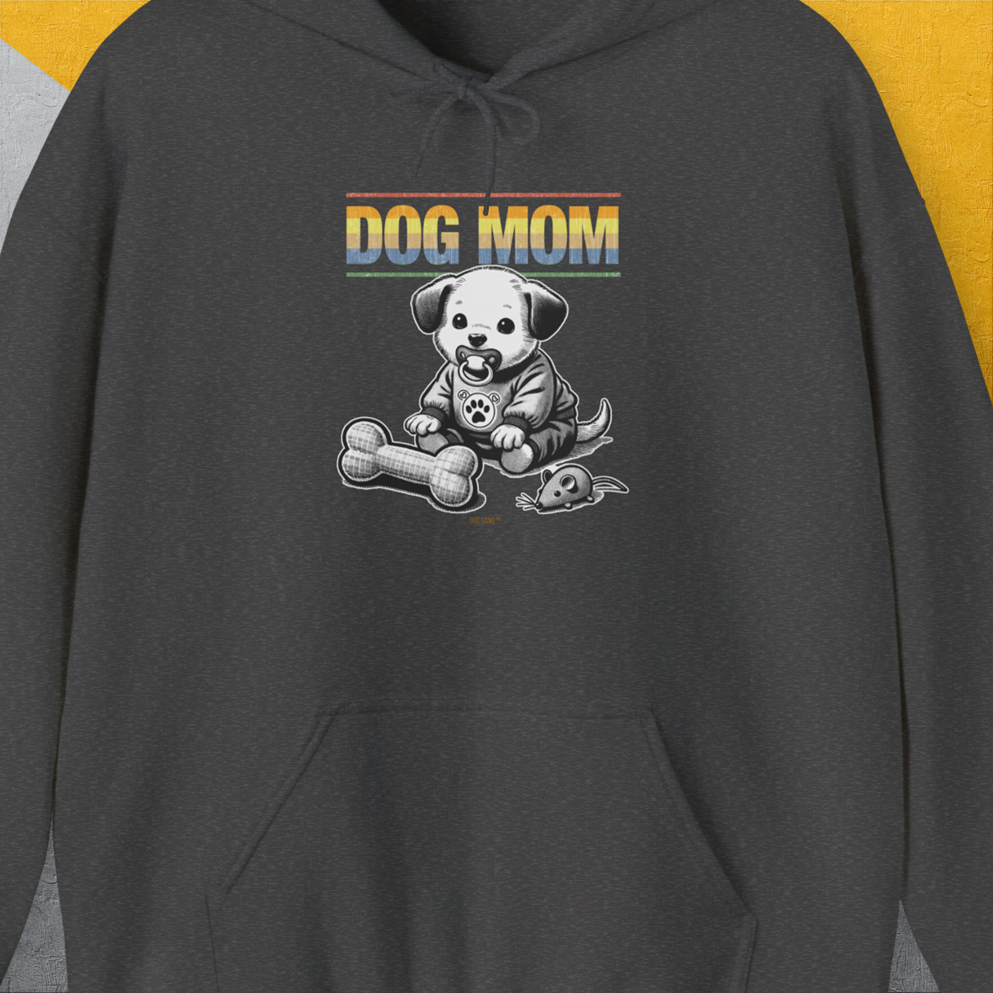The Dog Mom Series, Volume 2 hoodie shows Dog Mom with a cute cartoon puppy and fabric toy bone. Its a fun design for any dog lover. Designed by Dog Gang.