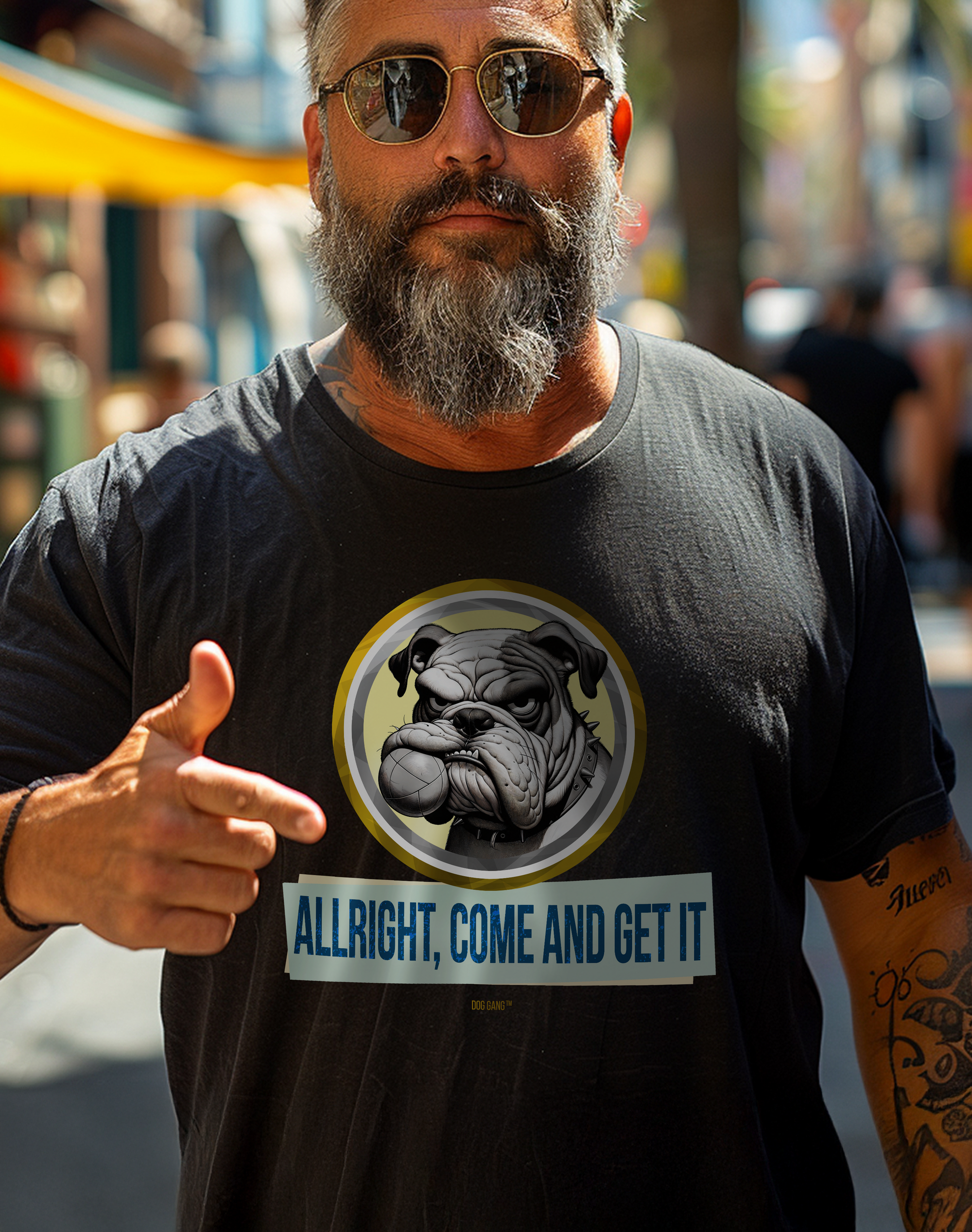 Man with beard wears a T-shirt by Swiss design label Dog Gang, which features a funny graphic of a bulldog with a fetch ball in its mouth and the slogan “ALLRIGHT, COME AND GET IT!”.