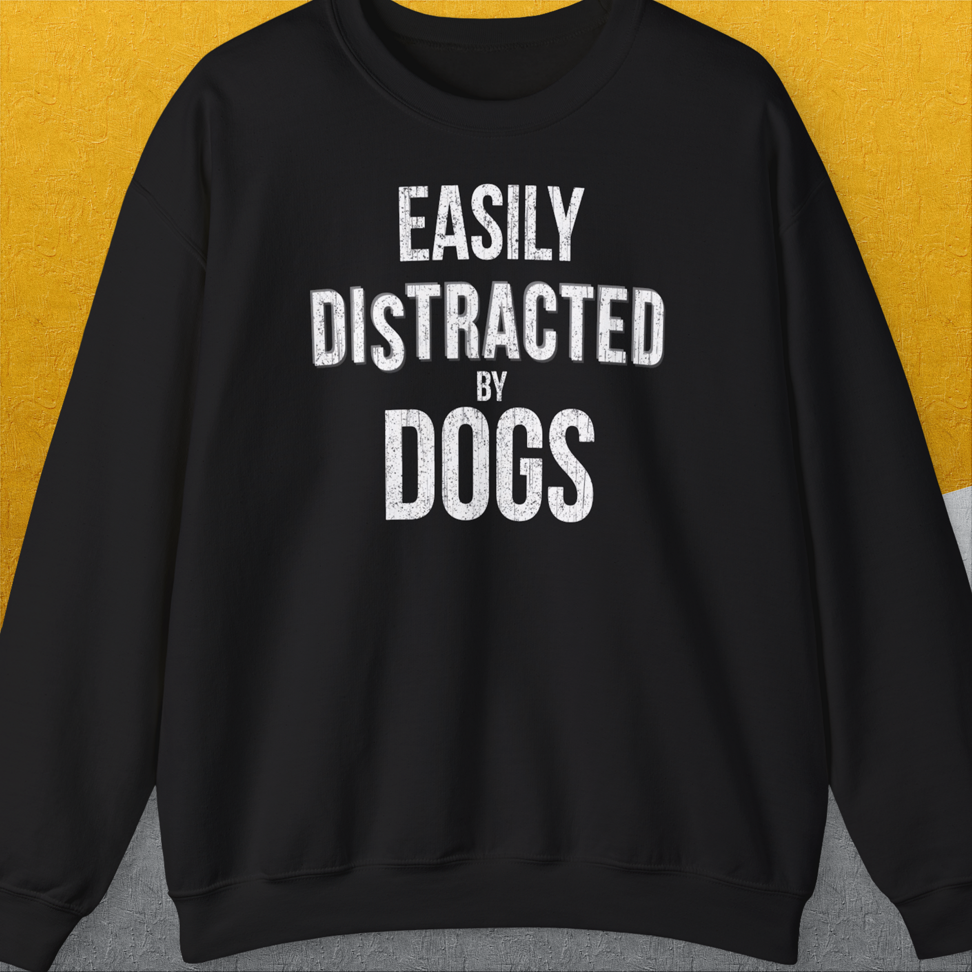 Featuring the quote Easily Distracted By Dogs, this vintage design is perfect for any dog person who loves a cozy blend of humor and style. Designed by Dog Gang.