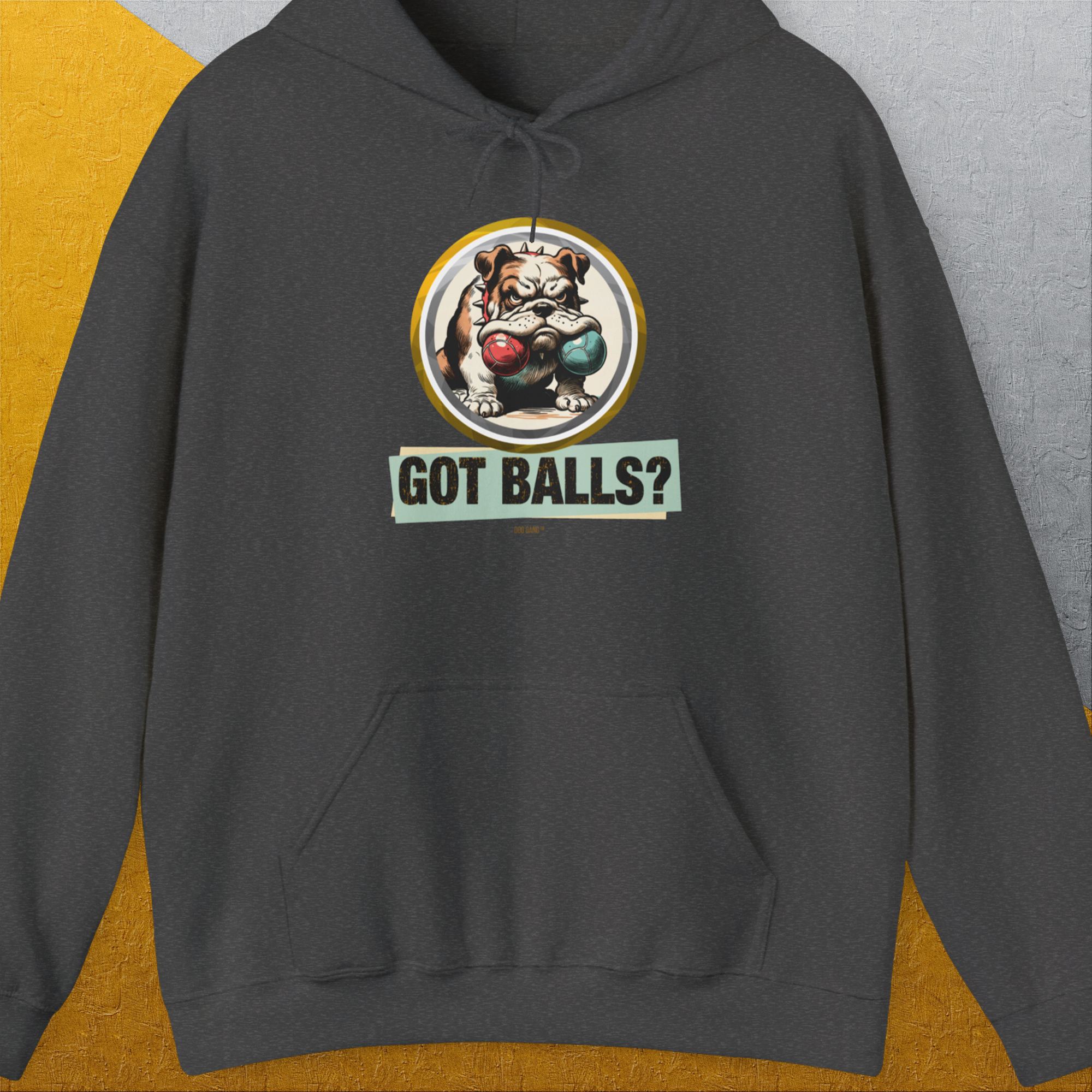 The funny dog ​​shirt "Got Balls?" shows a cheeky, grumpy bulldog holding two fetch balls in his mouth. Ideal for dog owners, it brings humor to your wardrobe. Volume 1 of the legendary GOT BALLS? series. Design by Dog Gang.