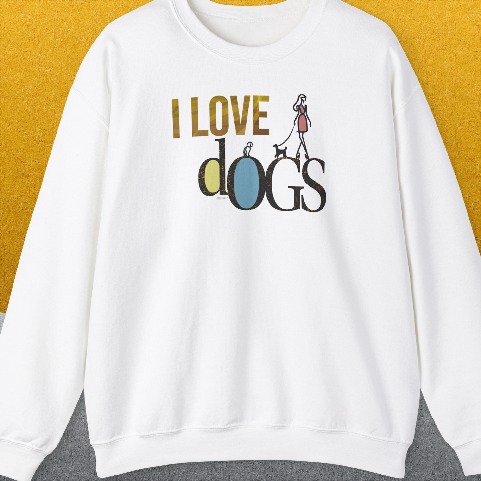 Funny dog shirt: The I Love Dogs - Series I, Volume 2 Unisex Sweatshirt in white displays I LOVE dogs with a person walking a dog on the word dogs, crafted from a cotton-polyester blend. Designed by Dog Gang.