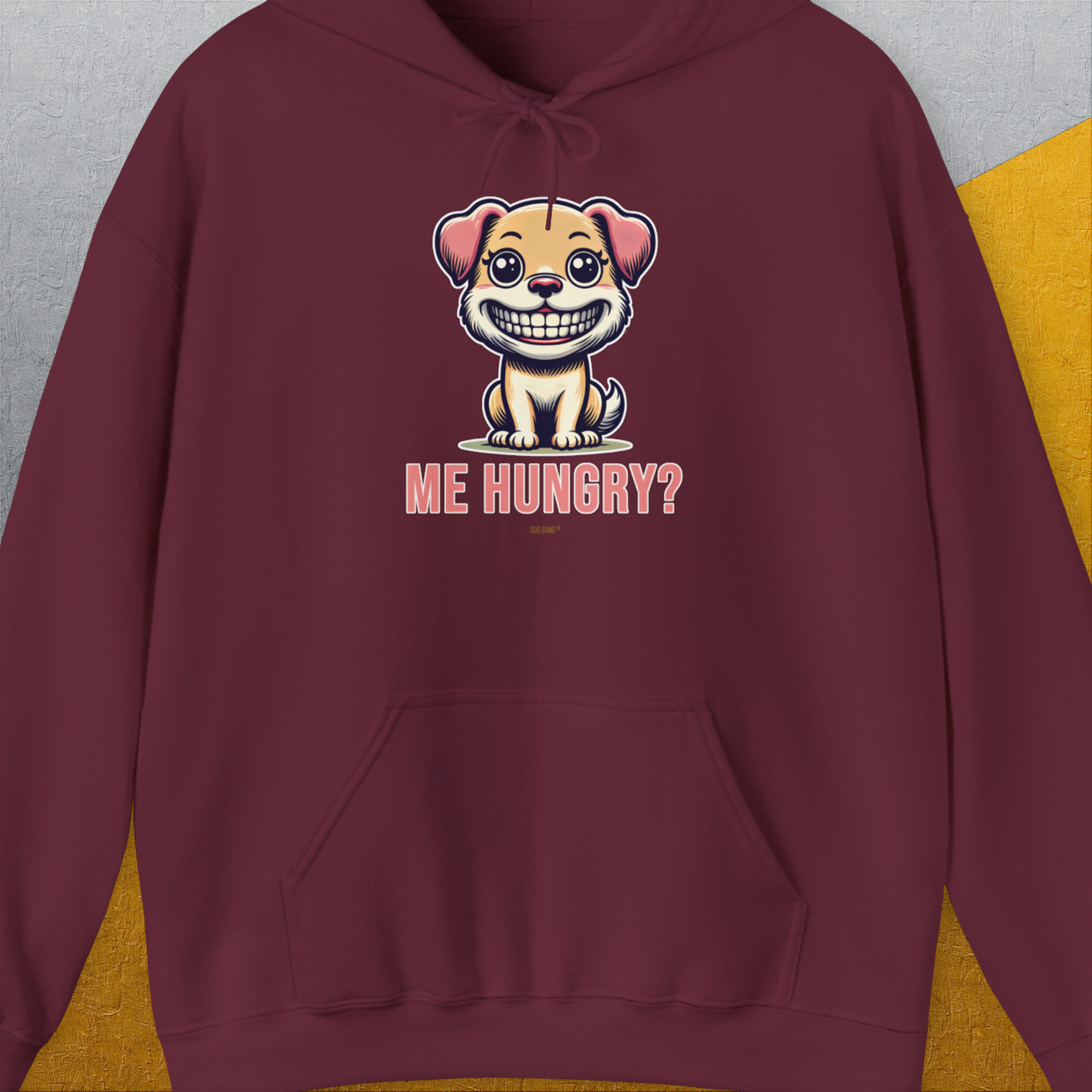 The maroon hoodie sports a cartoon puppy with the phrase ME HUNGRY? for a funny dog design. Designed by Dog Gang.