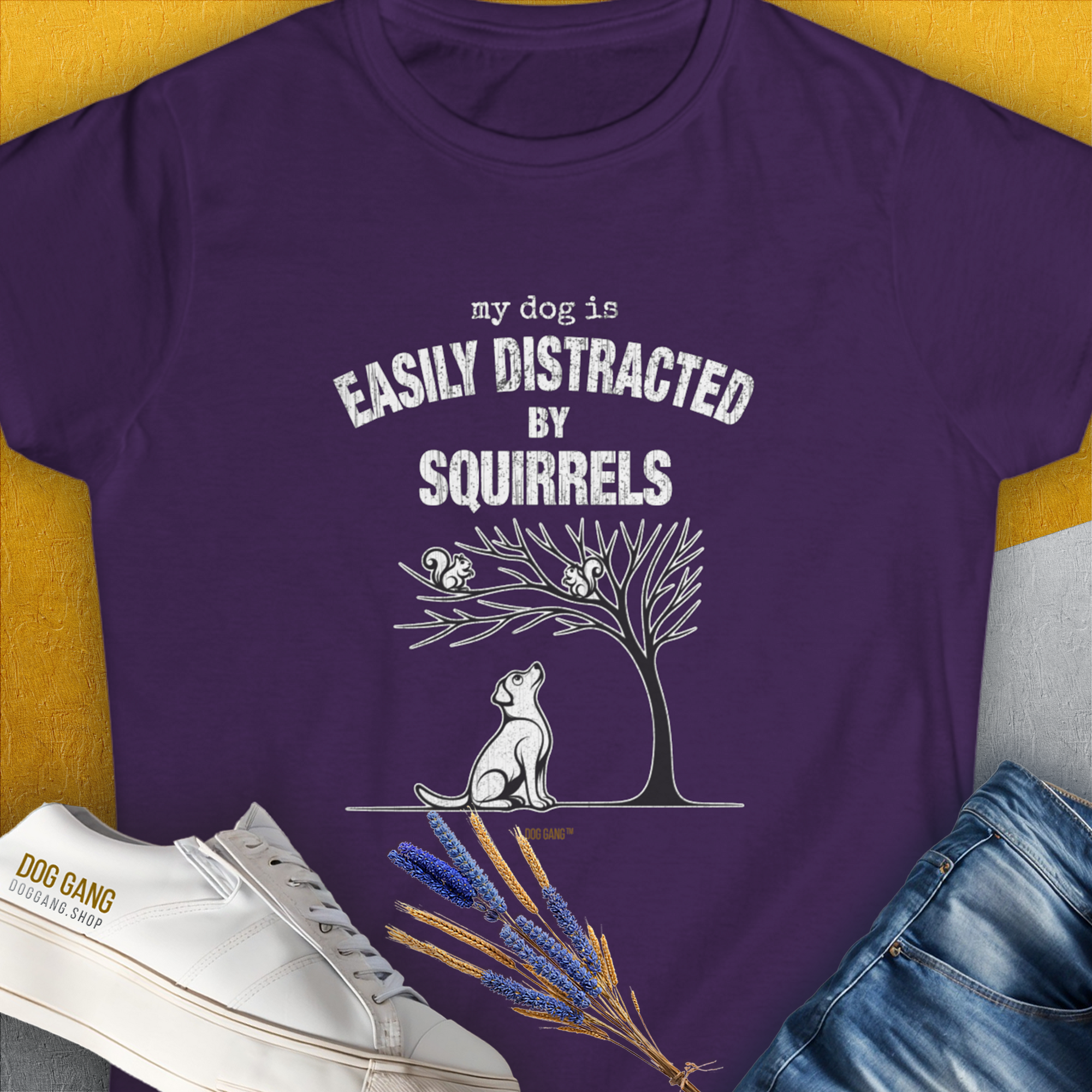 The purple shirt presents a funny dog watching squirrels, perfect for any dog lover. Designed by Dog Gang.