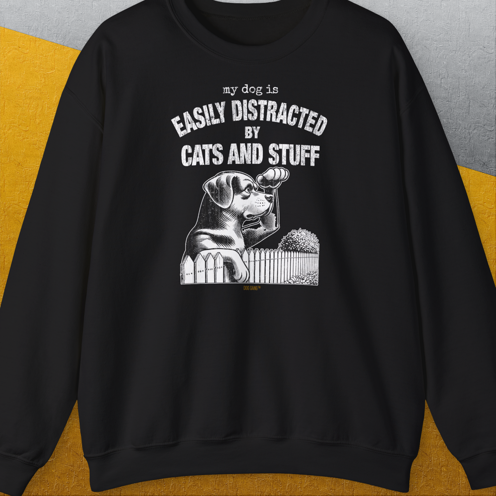 My Dog Is Easily Distracted By - Volume 2: Cats And Stuff features a cute dog design with a dog peeking over a fence. Designed by Dog Gang.