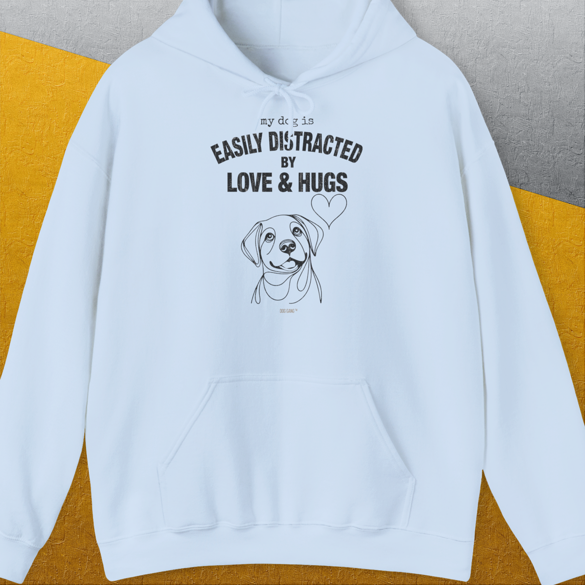 Light blue unisex hoodie with a cute dog design and the quote: My dog is easily distracted by love & hugs. Designed by Dog Gang.