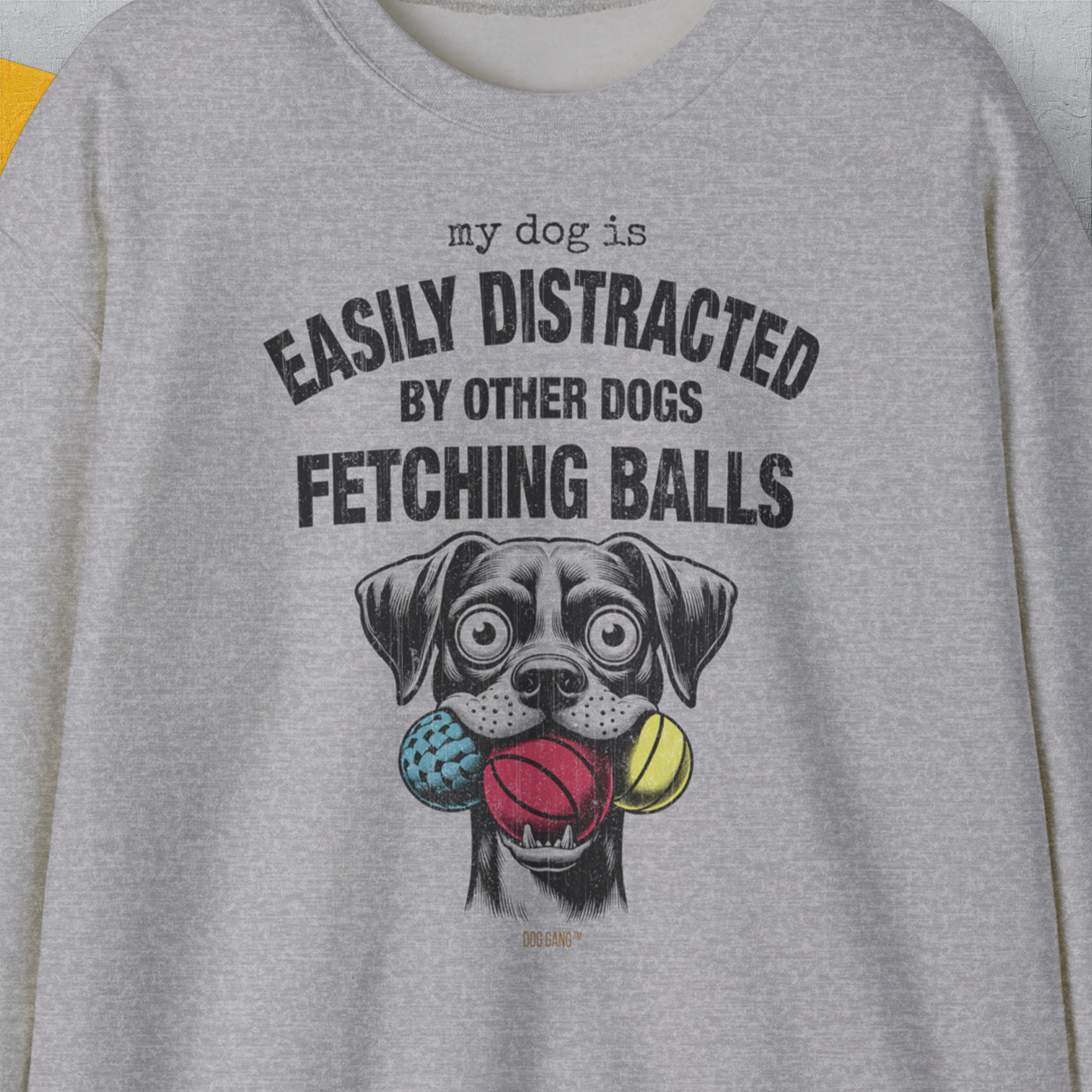 A unisex crewneck sweatshirt features a dog-themed design with the quote My Dog Is Easily Distracted By Other Dogs Fetching Balls, on ethically grown cotton. Designed by Dog Gang.